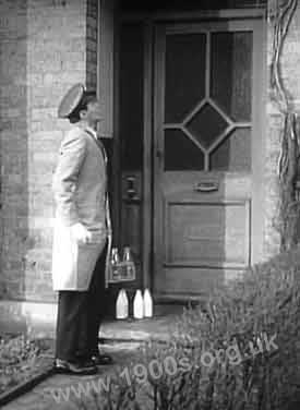 Milkman delivering milk to a home, 1940s-1950s England.