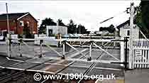 1940s and 1950s style level crossing closed to trains and open for road traffic, thumbnail