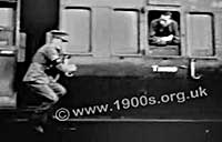 Someone jumping from an old British moving train because train doors could be opened by passengers even when moving, screen shot from an old film