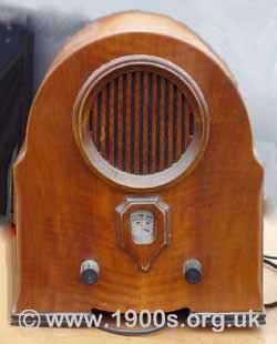 A 1940s radio with two knobs: one for on/off and volume and the other for tuning.
