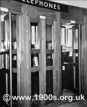 Wooden booths of public telephones as found in stations and other public places in 1940s abd 1950s Britain