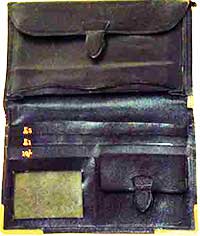 Man's leather wallet showing the labelling for 5&pound;, 1&pound; and 10 shilling notes, with only a single transparent pocket, probably intended for a train season ticket.