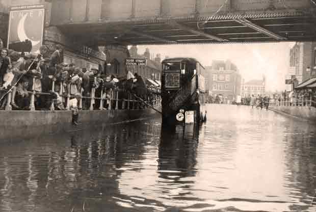 Flooding under a bridge c1920