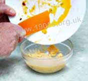 Fat left on a serving plate being added to dripping