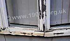 Flaking paintwork on old wooden windows
