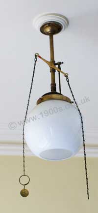 old gas ceiling lamp, showing its chains to control the flow of gas and hence the brightness of the glowing mantle.