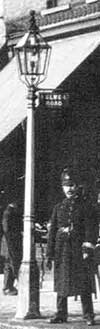 An old gas street lamp in the early 1900s showing the bar for the lamplighter to lean his ladder