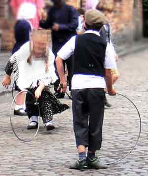 Children playing with old metal hoops