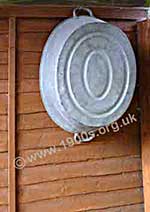 old Tin bath kept hanging on the fence outside the scullery door.