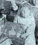 A girl at school in the early 1900s, showing her drawing on a slate