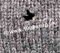Damage from the clothes moth in a knitted woollen garment